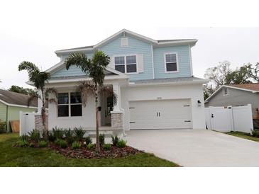 Two-story light blue house with white garage and landscaping at 5238 4Th S Ave, St Petersburg, FL 33707