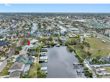 Expansive aerial view of waterfront home, featuring canal access and neighborhood details at 1104 Kingfish Pl, Apollo Beach, FL 33572