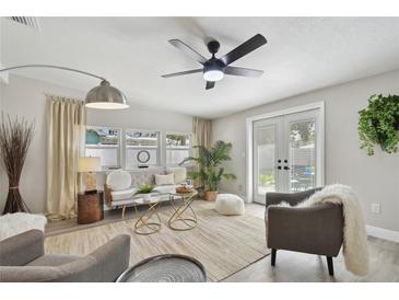 Bright and airy living room featuring comfortable seating and plenty of natural light at 6338 8Th S Ave, Gulfport, FL 33707