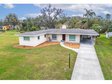 Ranch-style home with a large front yard, driveway and carport at 218 6Th Sw Ave, Ruskin, FL 33570