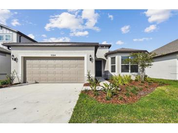 Charming single-Gathering home with a manicured lawn and two-car garage at 3584 Maple Bay Ln, Land O Lakes, FL 34638