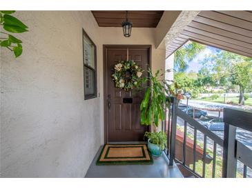 Inviting condo entry with a wreath and potted plants at 3505 Tarpon Woods Blvd # K409, Palm Harbor, FL 34685