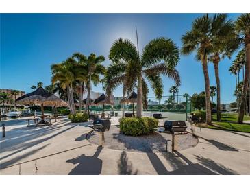 Community BBQ area with multiple grills and picnic tables at 7625 Sun Island S Dr # 101, South Pasadena, FL 33707