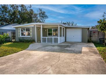 Charming one-story house with a gray exterior, white trim, and a carport at 6382 81St N Ave, Pinellas Park, FL 33781