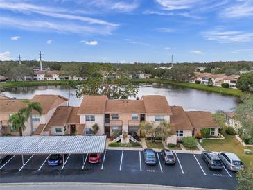 Aerial view showcasing condo community by a lake at 3840 Staysail Ln # 3840, Holiday, FL 34691