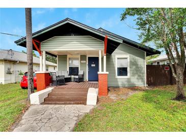 Charming craftsman home with a welcoming front porch and well-manicured lawn at 1312 E Louise Ave, Tampa, FL 33603