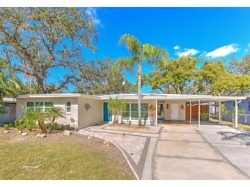 Attractive mid-century modern home with carport and landscaped yard at 8012 N Lynn Ave, Tampa, FL 33604