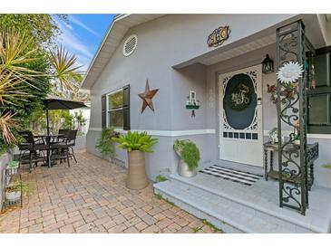 Inviting front porch with brick pavers, and charming entryway at 860 25Th N Ave, St Petersburg, FL 33704