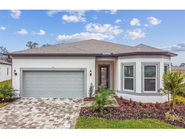 Attractive single-story home with gray garage door and landscaped yard at 9433 Barnacle Ln, Parrish, FL 34219