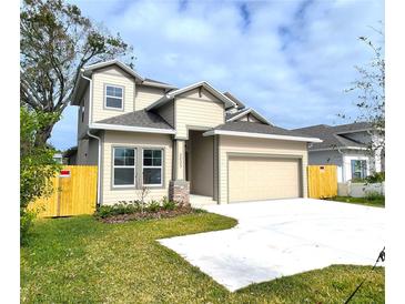 Two-story house with beige siding, gray roof, and a fenced backyard at 3033 54Th N Ave, St Petersburg, FL 33714