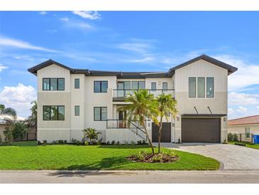 Two-story modern home with a two car garage and manicured lawn at 1954 Iowa Ne Ave, St Petersburg, FL 33703