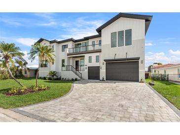 Luxury two story home with paver driveway and palm trees at 1954 Iowa Ne Ave, St Petersburg, FL 33703