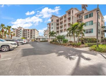 Parking lot with ample spaces and nearby building at 13313 Gasparilla Rd # 402, Placida, FL 33946