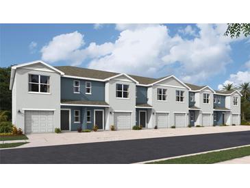 View of new two-story townhomes with attached garages and neutral two-tone exteriors at 4312 Red Banks Ln, Bradenton, FL 34208