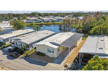 Beautiful aerial view of home with scenic pond and lush surroundings at 619 Pelican S Dr, Oldsmar, FL 34677