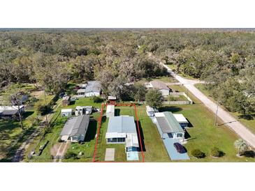 Aerial view of single-Gathering home with surrounding land at 1625 Thrush Dr, Zephyrhills, FL 33540