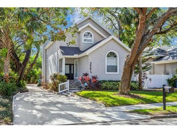 Charming two-story home with lush landscaping and mature trees, enhancing its curb appeal at 4628 W Longfellow Ave # 1/2, Tampa, FL 33629