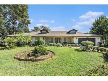 Single-story home with landscaped lawn and attached garage at 5105 N 45Th St, Tampa, FL 33610