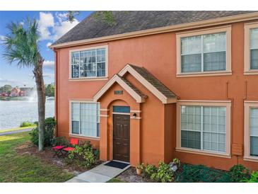 Charming townhome with a private entrance, lush landscaping, and serene lake views at 9320 Lake Chase Island Way, Tampa, FL 33626