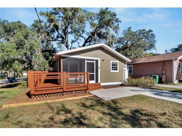 Cute bungalow with a screened porch and a deck, perfect for relaxing outdoors at 1100 E Louisiana Ave, Tampa, FL 33603