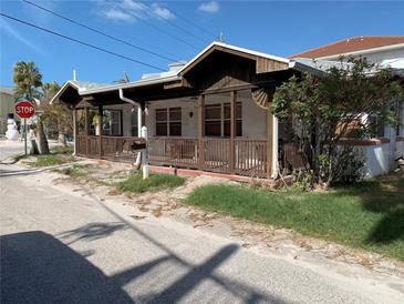 Quaint beach cottage with a covered porch and a fenced yard at 102 87Th Ave, Treasure Island, FL 33706