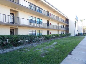 Two-story condo building with landscaped grounds and ample parking at 14130 Rosemary Ln # 2102, Largo, FL 33774