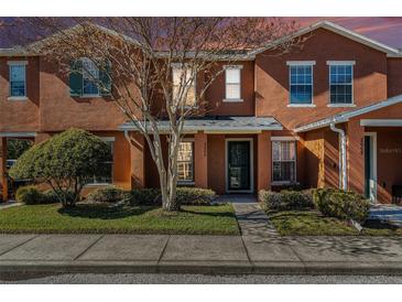 Two-story townhome with a charming front porch and landscaping at 2066 Sun Down Dr 2066 Sun Down Dr, Clearwater, FL 33763