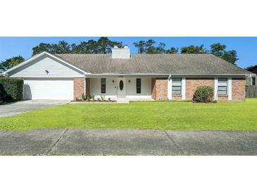 Brick ranch house with attached garage and well-manicured lawn at 2308 Long Green Ct, Valrico, FL 33596