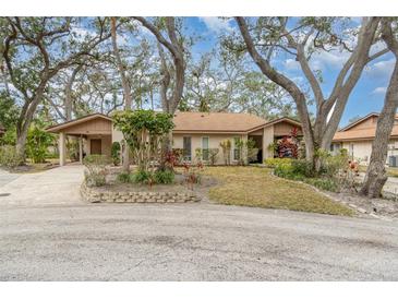 Charming single-story home featuring a covered carport, mature trees, and well-maintained landscaping at 5110 28Th W St, Bradenton, FL 34207