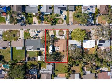 Aerial view of a single-Gathering home with a well-maintained yard and mature trees, set in a quiet residential neighborhood at 4145 Harrisburg Ne St, St Petersburg, FL 33703