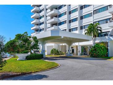 White building exterior with landscaping and covered entrance at 30 Turner St # 201, Clearwater, FL 33756