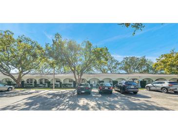 Charming condo building featuring a well-maintained façade and ample parking under the shade of mature trees at 11200 102Nd N Ave # 66, Seminole, FL 33778