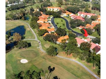 Aerial view of a community with golf course and villas at 1120 Tartan Dr, Palm Harbor, FL 34684