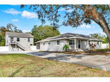 Two-story house with attached guest house and spacious driveway at 205 W 122Nd Ave, Tampa, FL 33612