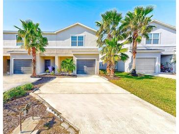 Tan two-story townhome with two-car garage and lush landscaping at 4781 Vignette Way, Sarasota, FL 34240