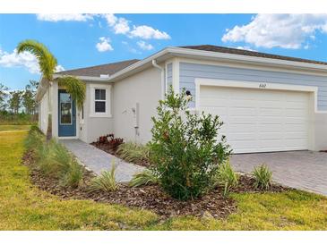 Exterior view of a single-Gathering home with a two-car garage and landscaped front yard at 6162 Timberdale Ave, Wesley Chapel, FL 33545