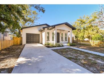 Modern craftsman home with dark gray garage door and walkway at 1565 13Th S St, St Petersburg, FL 33705