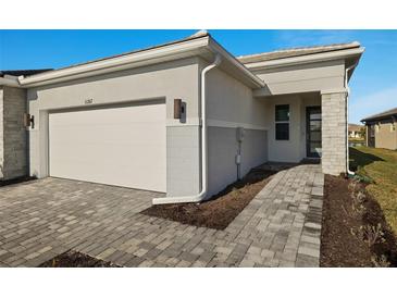 House exterior featuring a two-car garage and a walkway at 11267 Boundless Ter, Venice, FL 34293