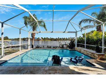 Relaxing pool area with screened enclosure, offering water views and comfortable seating at 5205 Covesound Way, Apollo Beach, FL 33572