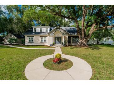 Charming brick home with a spacious lawn and mature trees at 37439 Meridian Ave, Dade City, FL 33525