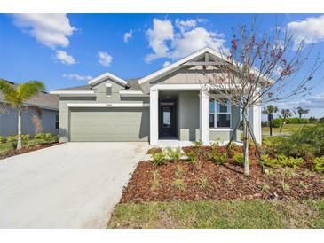 Charming single-story home with a neutral color scheme, well-manicured landscaping, and a two-car garage at 11826 Richmond Trl, Parrish, FL 34219