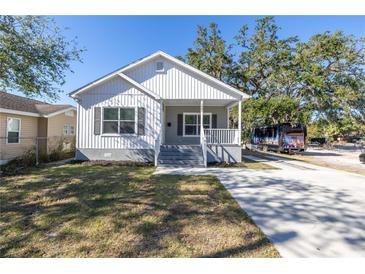 Charming home with a well-manicured lawn and a freshly paved driveway at 1521 Preston S St, St Petersburg, FL 33712