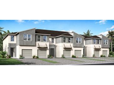 Three-unit townhome building with modern design, attached garages, and landscaping at 31471 Woodland Race Loop, Wesley Chapel, FL 33545