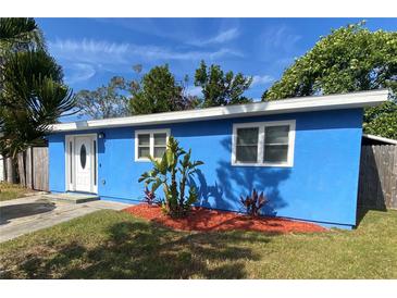 Newly renovated blue house with a landscaped front yard at 5135 Newton S Ave, Gulfport, FL 33707