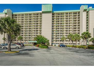 Envoy Point West building exterior, featuring ample parking at 7100 Sunset Way # 205, St Pete Beach, FL 33706