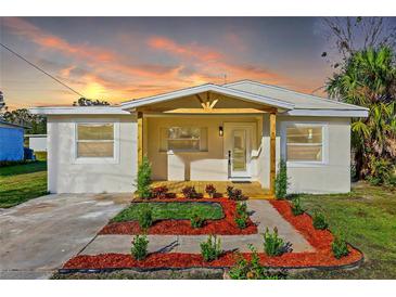 Newly renovated home with a welcoming front porch and well-manicured landscaping at 712 E Madison St, Plant City, FL 33563