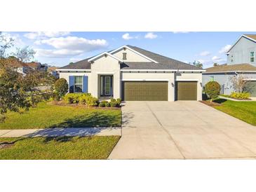 Beautiful two-story home with a two-car garage and lush lawn at 8321 Sky Eagle Dr, Tampa, FL 33635