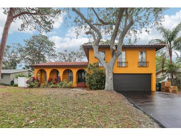 Charming two-story home with arched entry, tile roof, mature landscaping and two car garage at 14160 82Nd Ter, Seminole, FL 33776