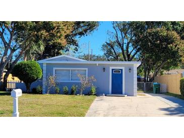 Charming single-story home with a well-manicured front yard and a striking blue front door at 13625 120Th St, Largo, FL 33778