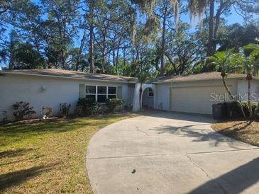 Single story home with a two-car garage and driveway at 12961 Sophia Cir, Largo, FL 33774